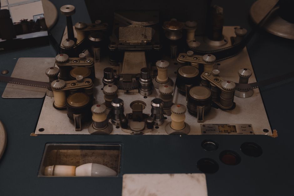 Closeup view of vintage film editing equipment, showcasing knobs and reels, perfect for retro film themes.