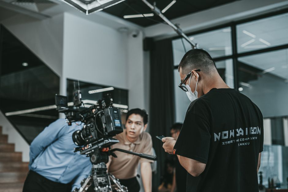 Camera crew working on a film set in Vietnam, capturing cinematic scenes indoors.
