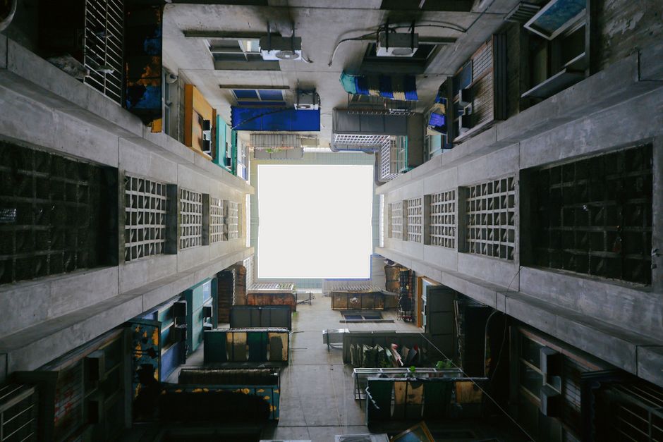 A unique perspective from the bottom of an urban alleyway looking upwards.