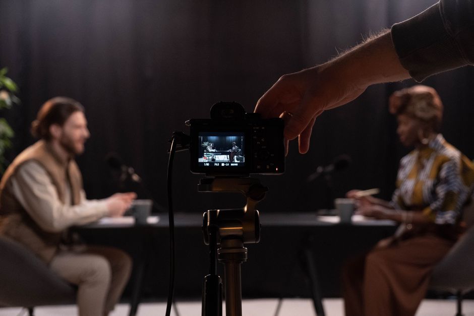 Professional podcast session recording with diverse hosts in studio.