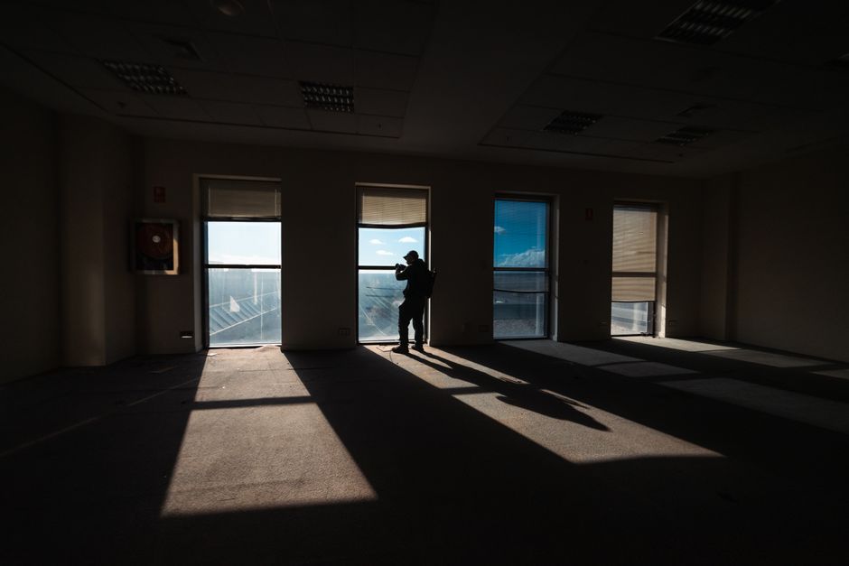 A photographer captures the view from an empty office with striking shadows on the floor.