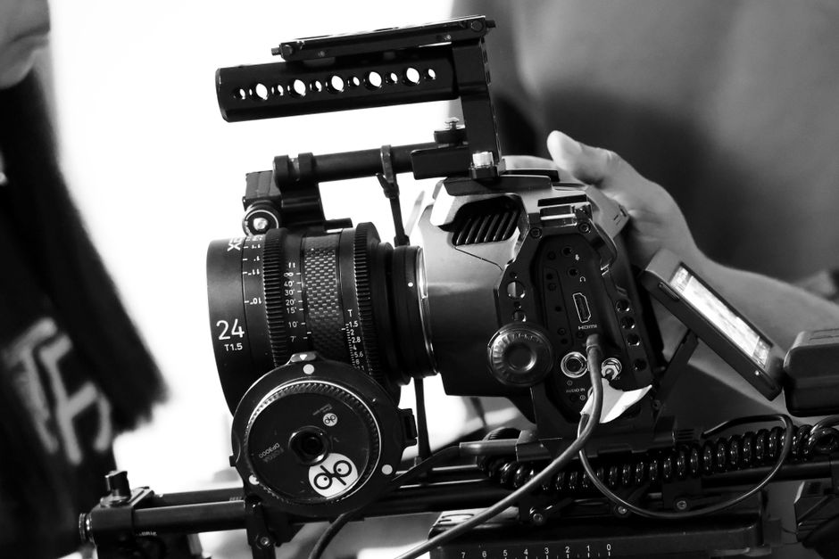 Detailed view of a professional movie camera rig in black and white, showcasing filmmaking equipment.