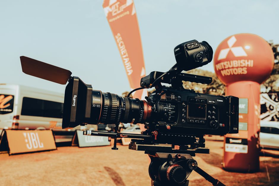 High-end video camera setup at an outdoor car event, displaying advanced filming equipment.