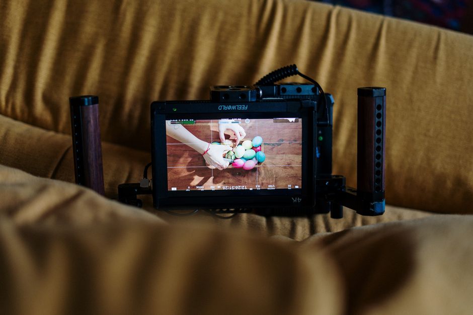 Artistic process of filming colorful Easter egg decoration with a professional camera.