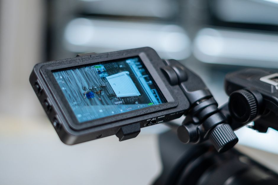 Close-up view of a camera monitor displaying captured footage with detailed settings.