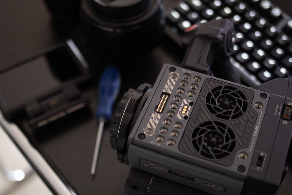 Detailed view of professional camera gear on a desk, showcasing advanced technology and precision.