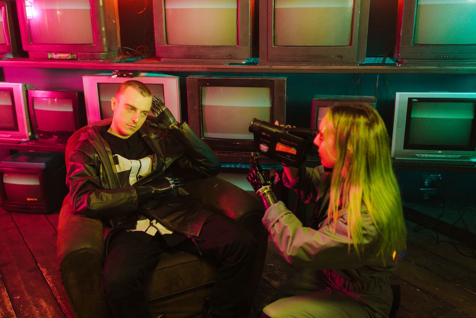 Cyberpunk themed image with neon colors, featuring individuals and retro tech.