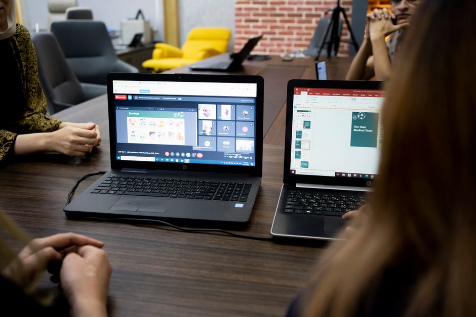 Team discusses projects during a virtual and in-person meeting in a Dubai office.