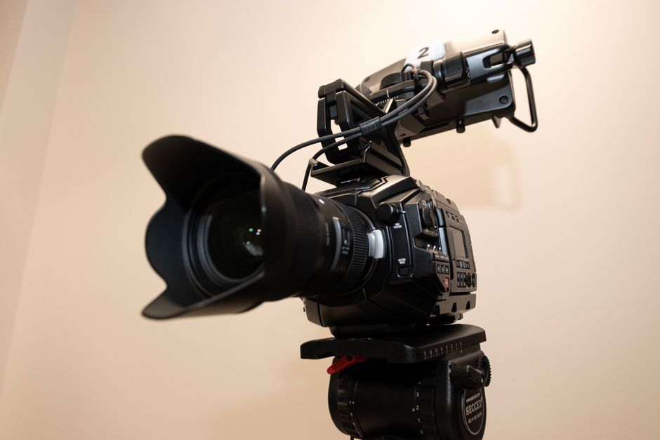 Close-up of a professional studio camera mounted on a tripod, ideal for filming projects.