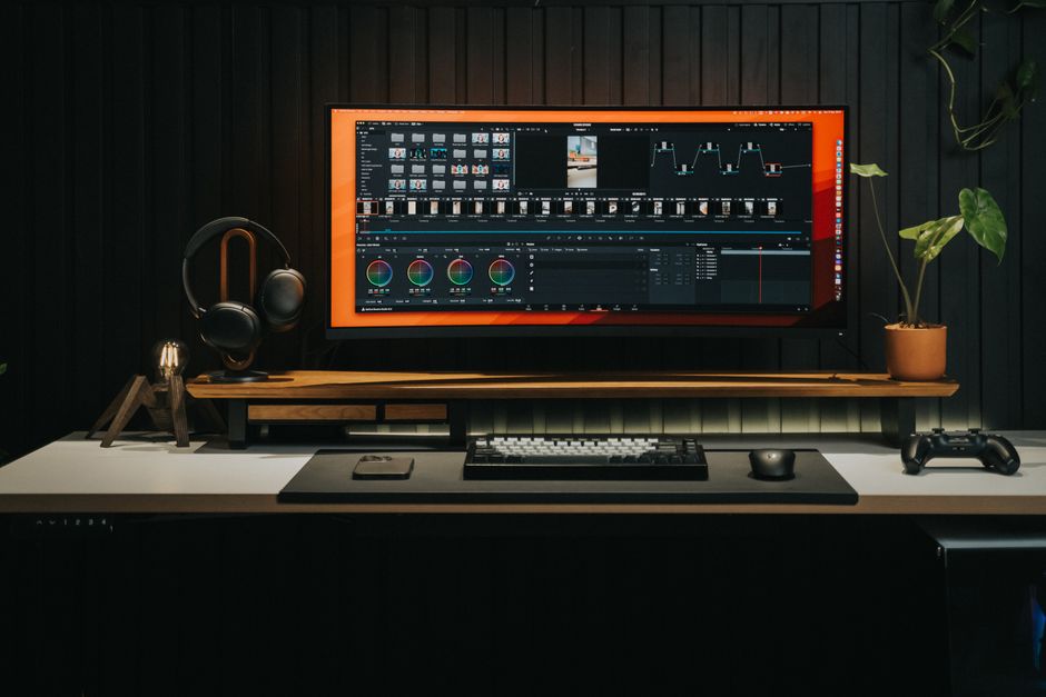 Sleek home office with a powerful video editing workstation and gaming console, perfect for creators.