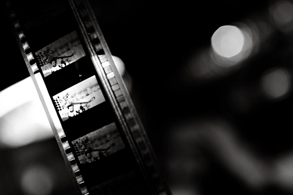 A close-up of a vintage film strip in black and white, capturing the essence of classic cinema.