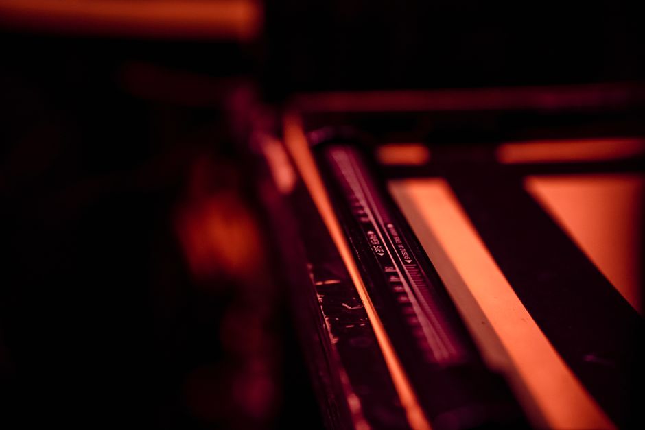 Close-up of darkroom photography equipment in a warm, defocused ambiance.
