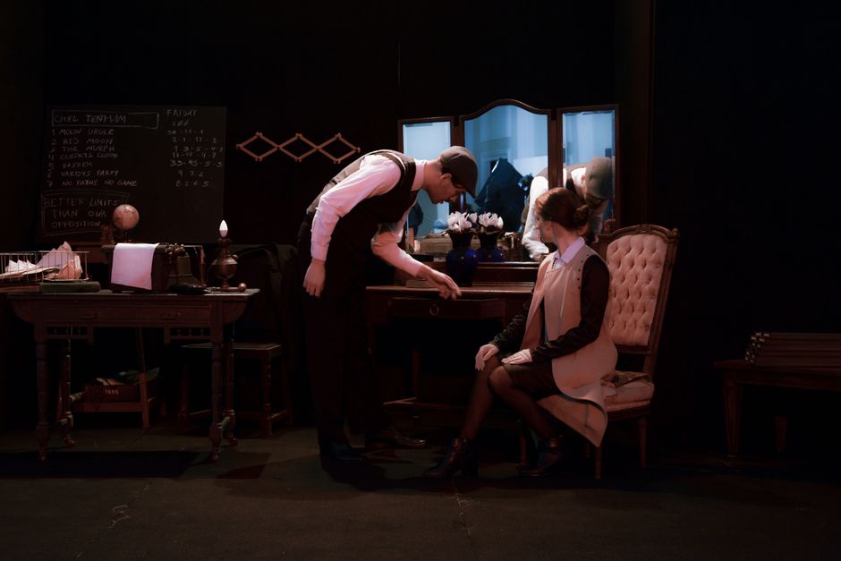 Actors in period costumes perform a scene on stage in Mar del Plata theater.