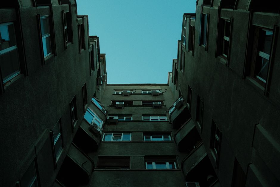 Upward shot of residential building showing dramatic lines and minimalist Soviet architecture.
