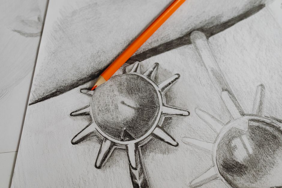Detailed close-up of a pencil sketch with an orange pencil on top, creating a creative art piece.