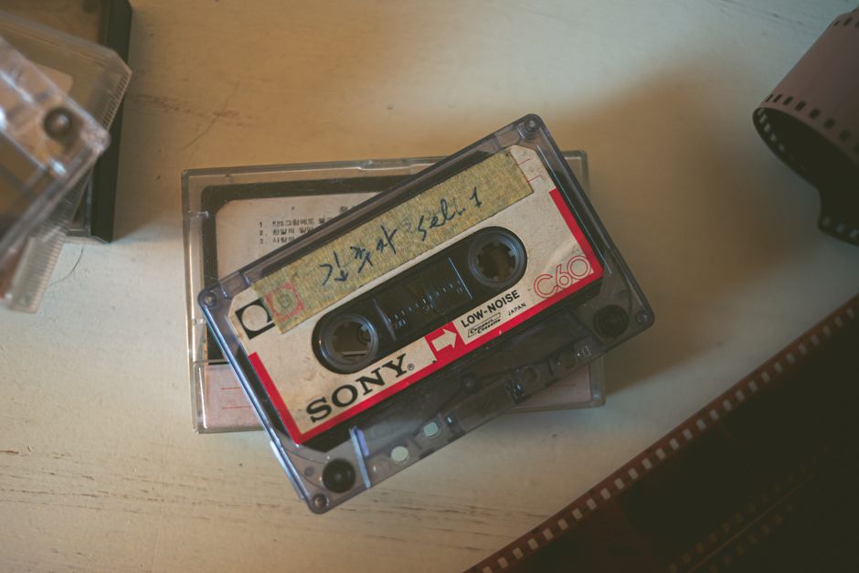 Close-up of a vintage Sony cassette tape on a wooden surface, evoking nostalgia.