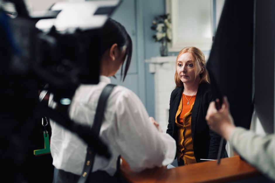 A behind-the-scenes look at a fashion shoot with women in conversation.