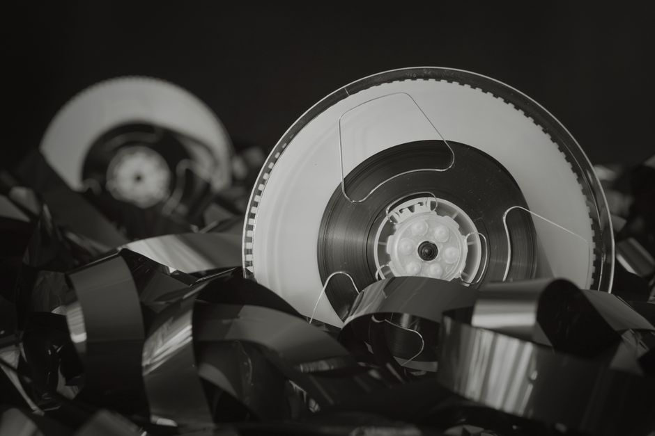 Close-up of vintage reel tape with tangled film, exuding a retro feel.