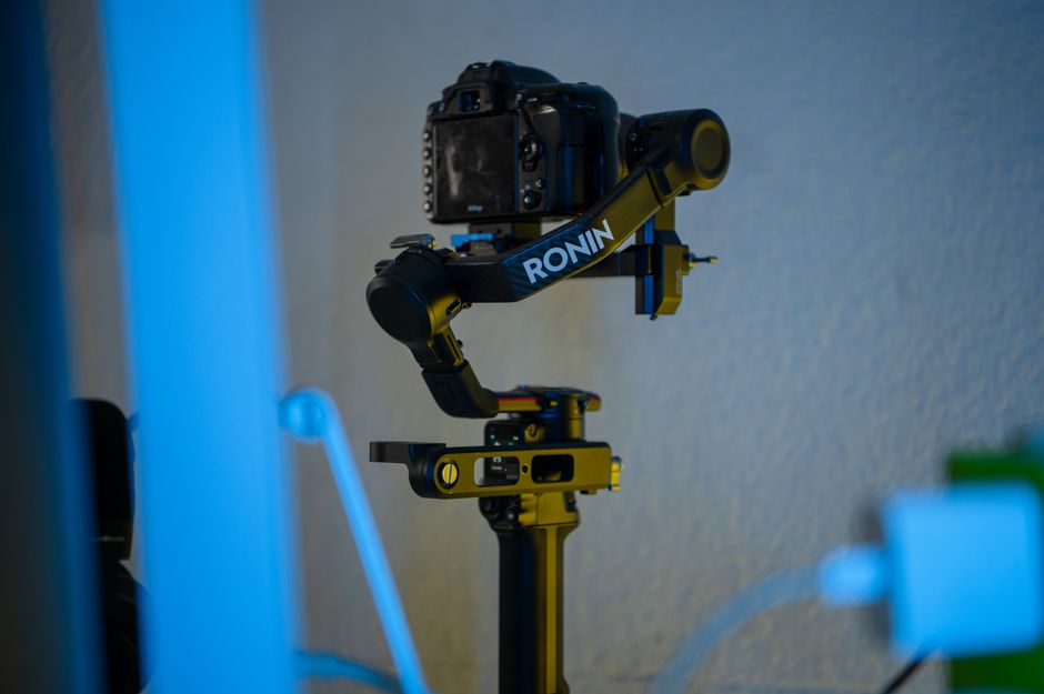 A professional camera mounted on a Ronin stabilizer in an indoor setting, offering smooth filming capabilities.