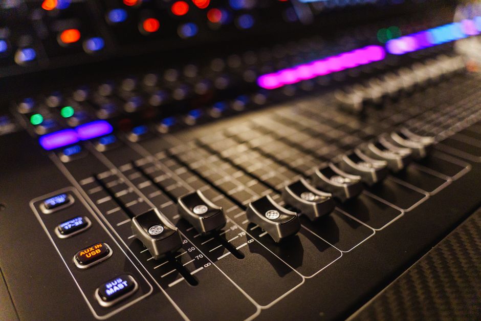 Detailed view of an advanced audio mixing console, perfect for studios.