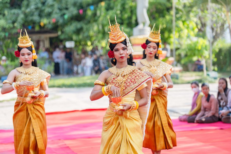 Three women perform a traditional Khmer dance in Battambang, showcasing Cambodian cultural heritage.