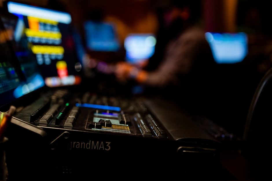 Dimly lit studio showcasing a sophisticated audio mixer with colorful displays.