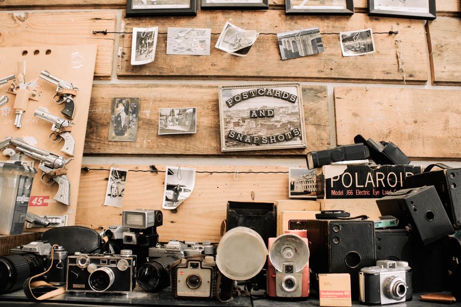 A nostalgic display of vintage cameras and memorabilia in an antique shop setting.