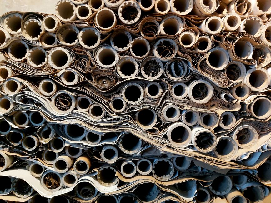 Close-up view of stacked rolled paper tubes, showcasing texture and patterns.