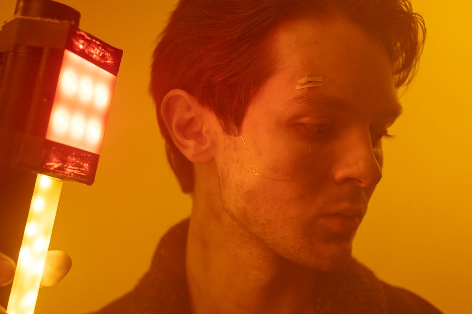 Moody portrait of a man with cyberpunk style and neon lighting, showcasing futuristic aesthetics.