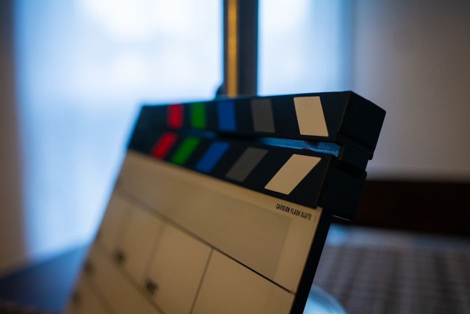 Detailed view of a film clapperboard indoors, highlighting film industry tools.
