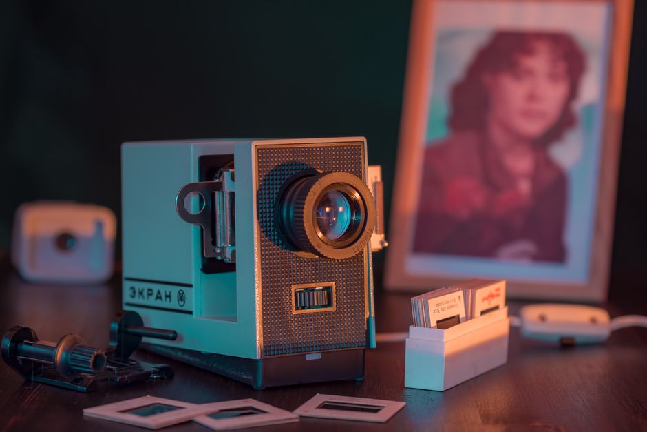 A nostalgic close-up of a vintage slide projector setup with a photo frame, evoking retro vibes.