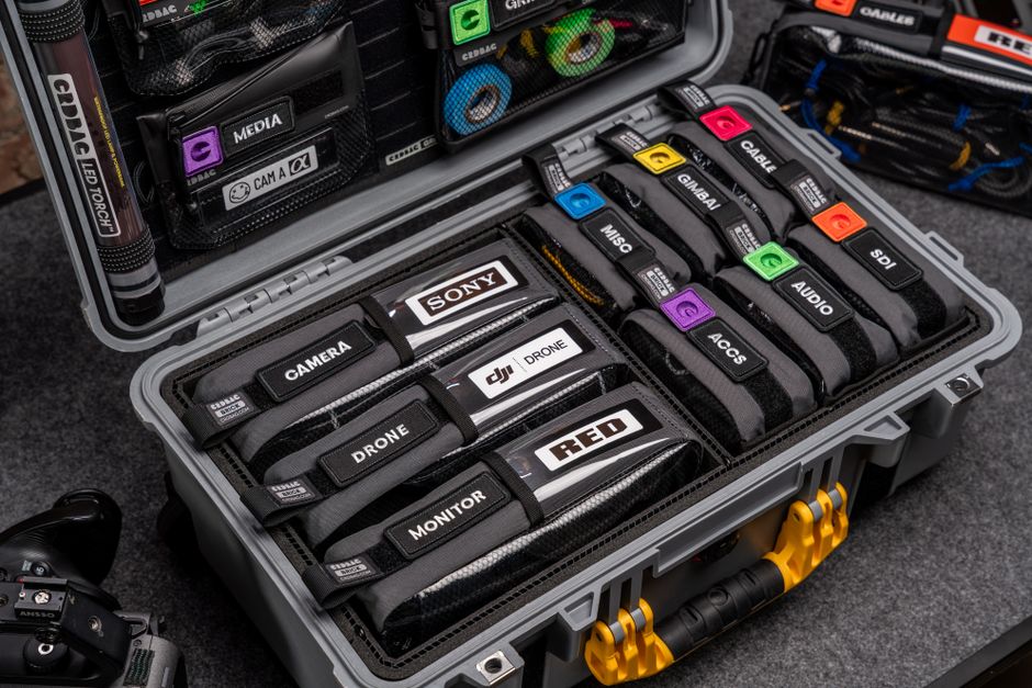 Neatly organized camera equipment in durable hardcase for travel and protection.
