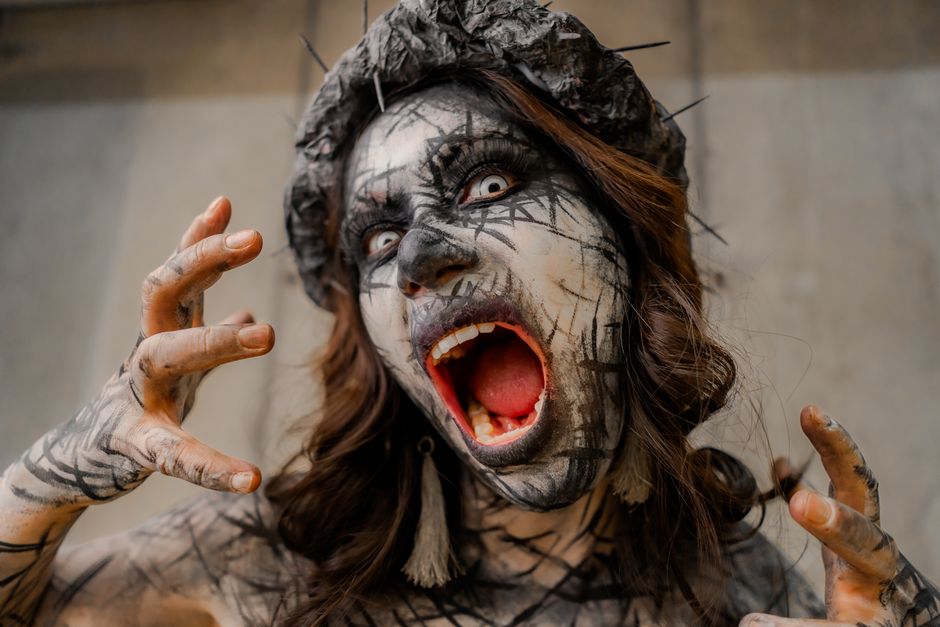 A gripping surreal horror portrait featuring intense makeup and expression.