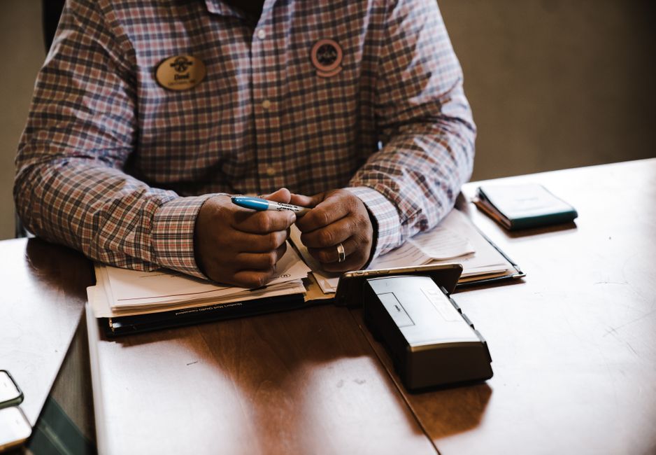 A businessman with documents, organizing and working at his desk for an office task.