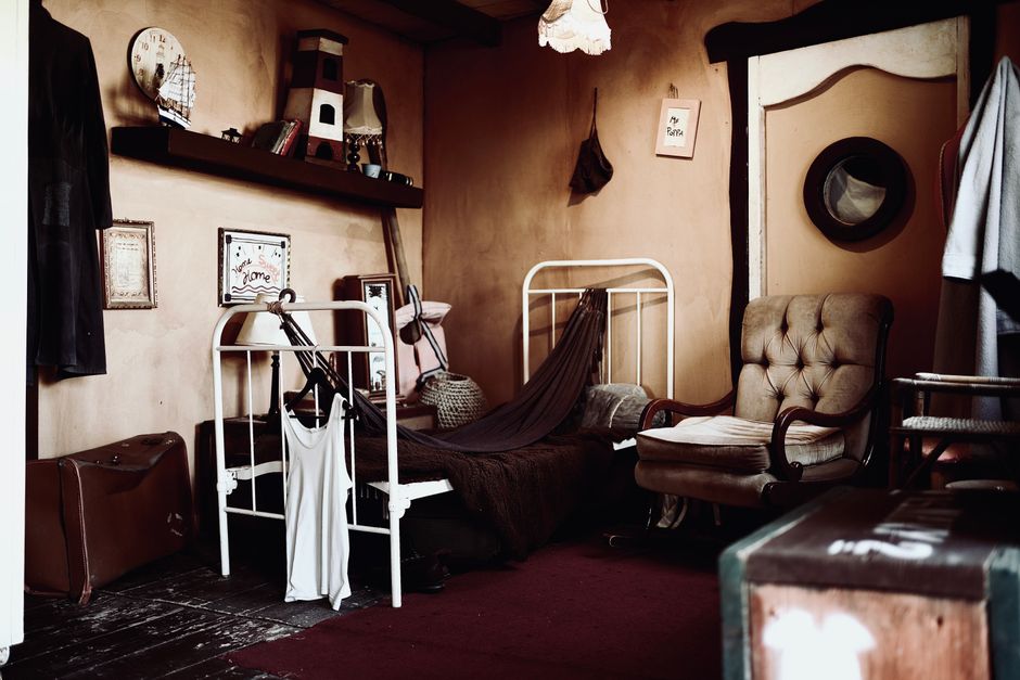 Cozy vintage bedroom interior with rustic decor, armchair, and stylish details.
