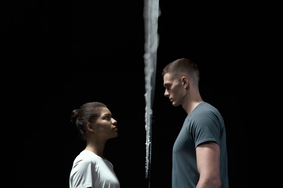Two people facing each other with a barrier between them, conveying confrontation