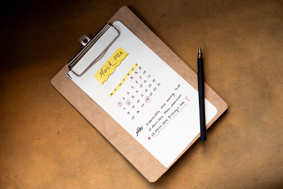Top view of a March 2024 calendar on a clipboard with a pen, ideal for planning or scheduling content.