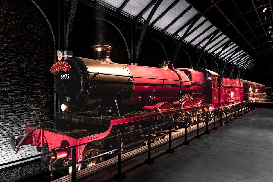 Iconic Hogwarts Express locomotive displayed in a captivating indoor train station setting.