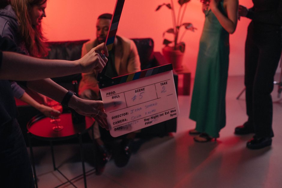 Behind the scenes of a movie set in a stylish indoor setting with clapperboard ready for action.