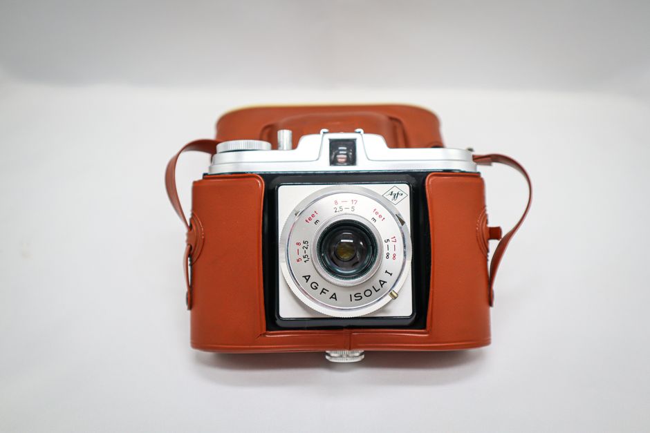 Classic Agfa Isola I camera with leather case captured in a minimalist style.
