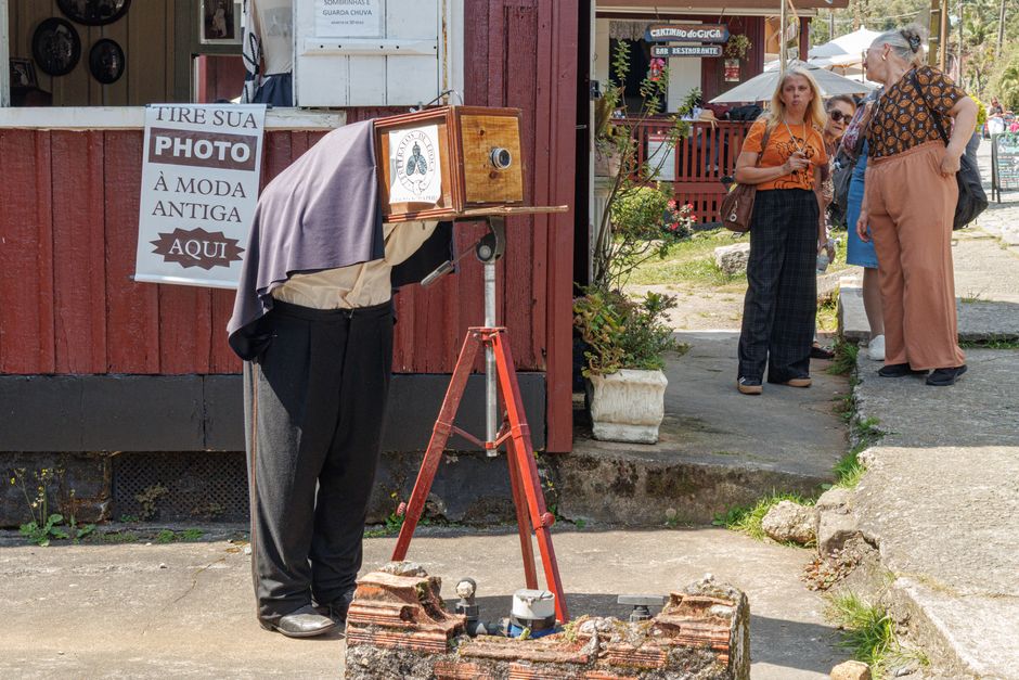 A photographer using an antique camera setup in Paranapiacaba, São Paulo, Brazil.