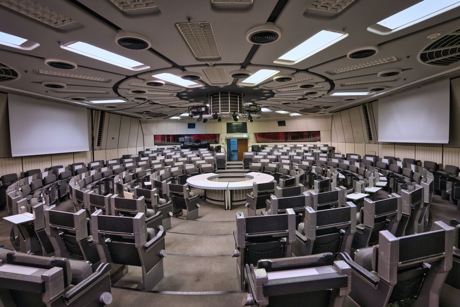 Empty futuristic conference room in Berlin ICC with circular seating and high-tech design.