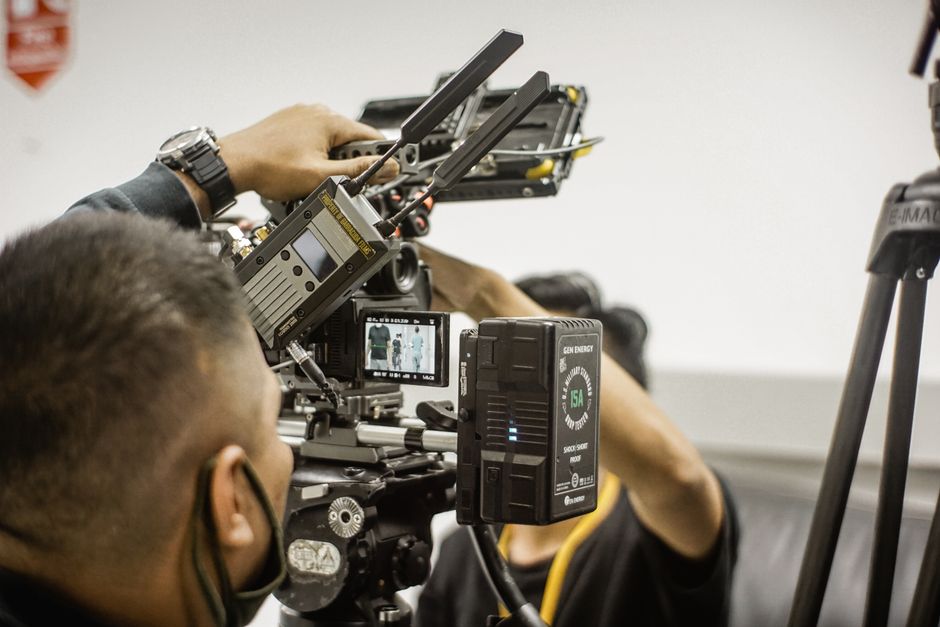 Close-up of advanced filmmaking equipment being used by professionals indoors.