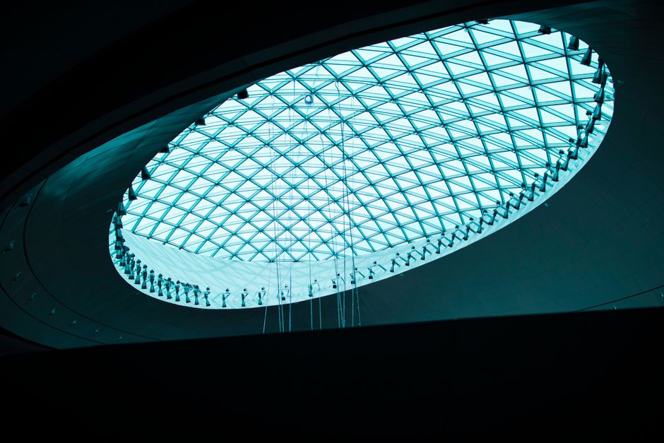 Captivating view of a geometric glass ceiling with modern architecture design, featuring metal frames and elegant symmetry.
