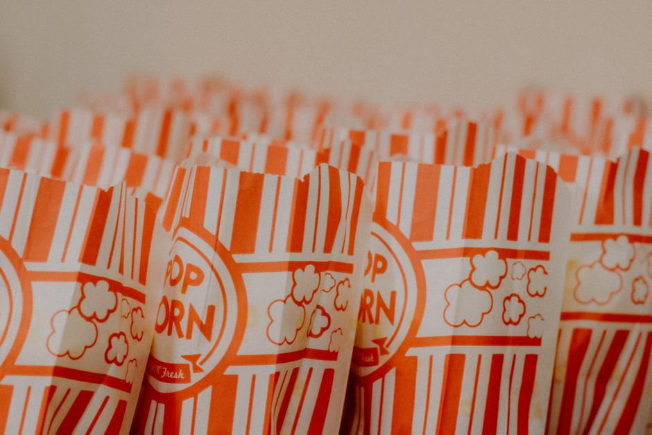 Close-up of popcorn bags with red stripes, ready for movie night or party.