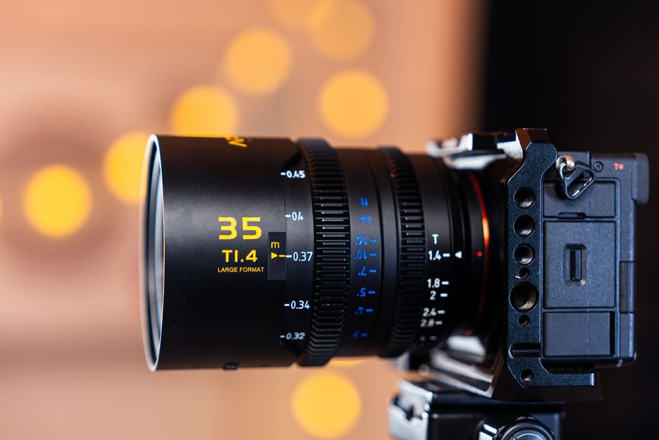 Close-up of a large format 35mm camera lens with cinematic bokeh effect lighting.