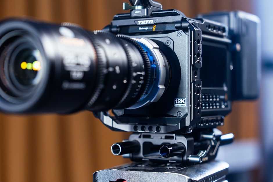 High-quality close-up of a modern 12K video camera on a tripod, showcasing advanced film equipment.