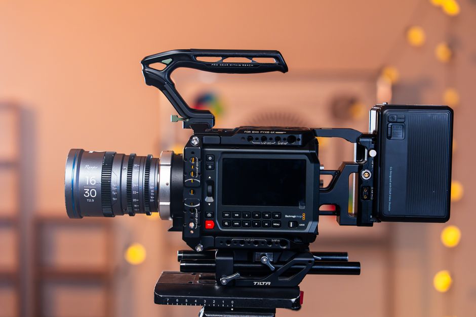 Side view of a professional cinema camera setup on a tripod, ideal for film production indoors.