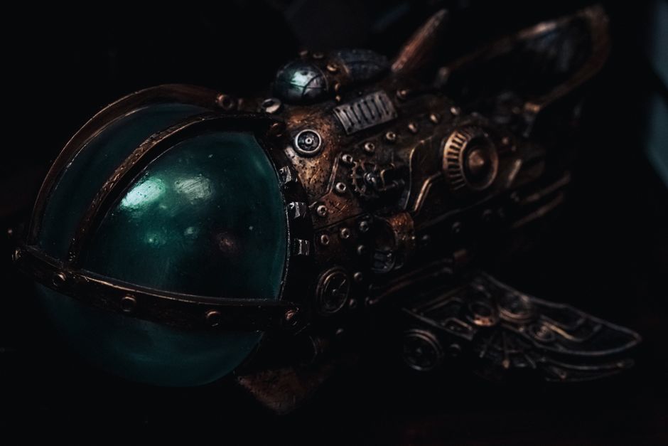 Close-up of a detailed steampunk miniature submarine model with brass gears and glass dome.